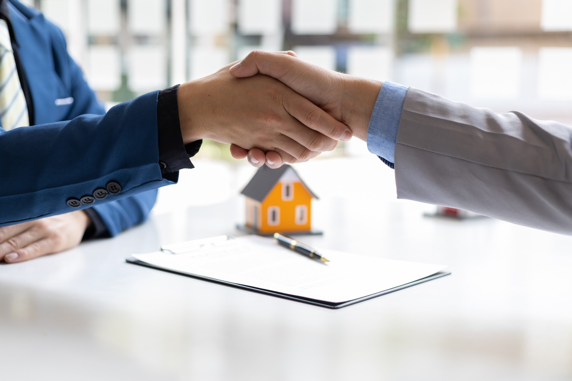 Businessman handshake after reaching a real estate deal. Signing a house rental, mortgage, lease, contract agreement.